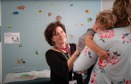 Pediatric doctor talking to a mother and child